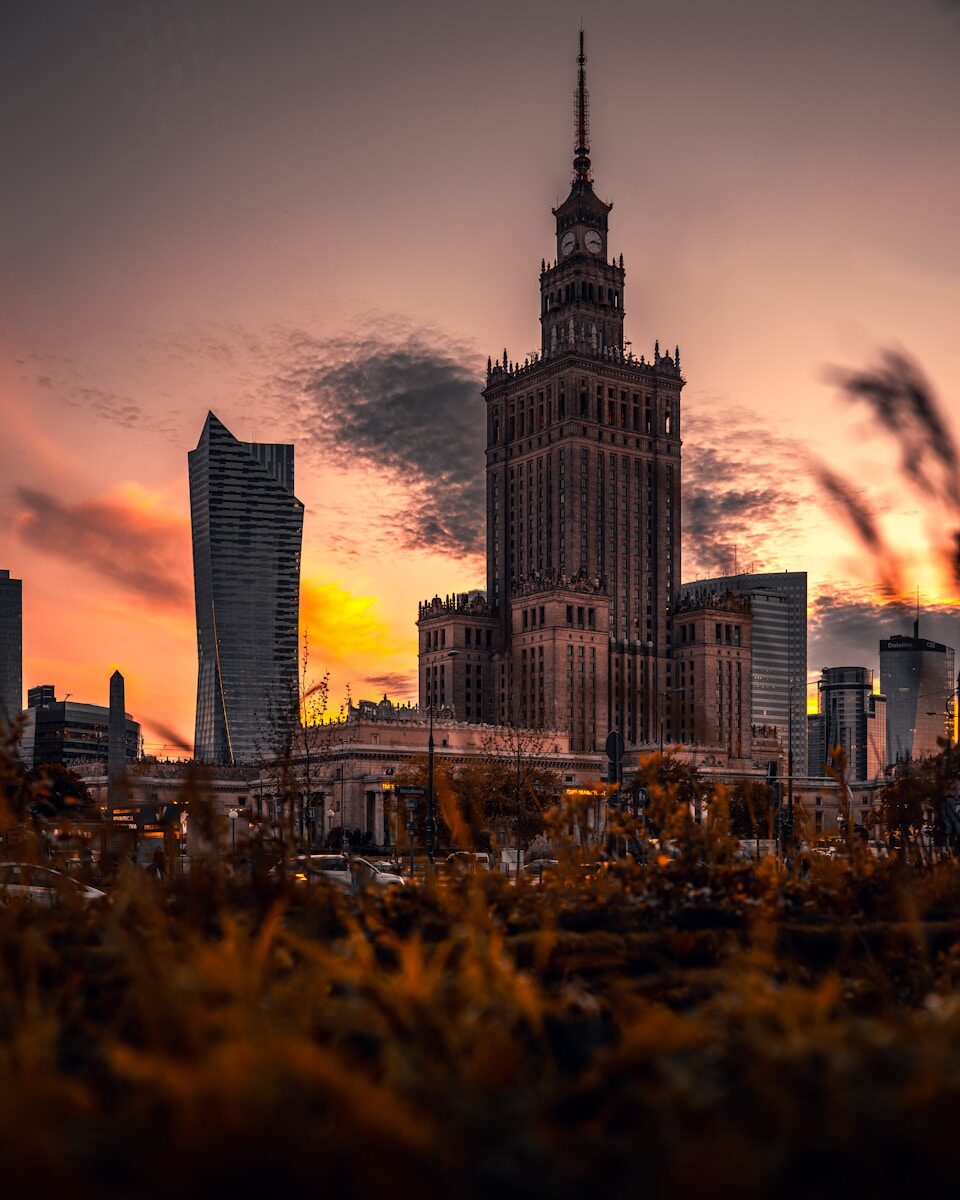 a tall building with a clock tower in the middle of a city