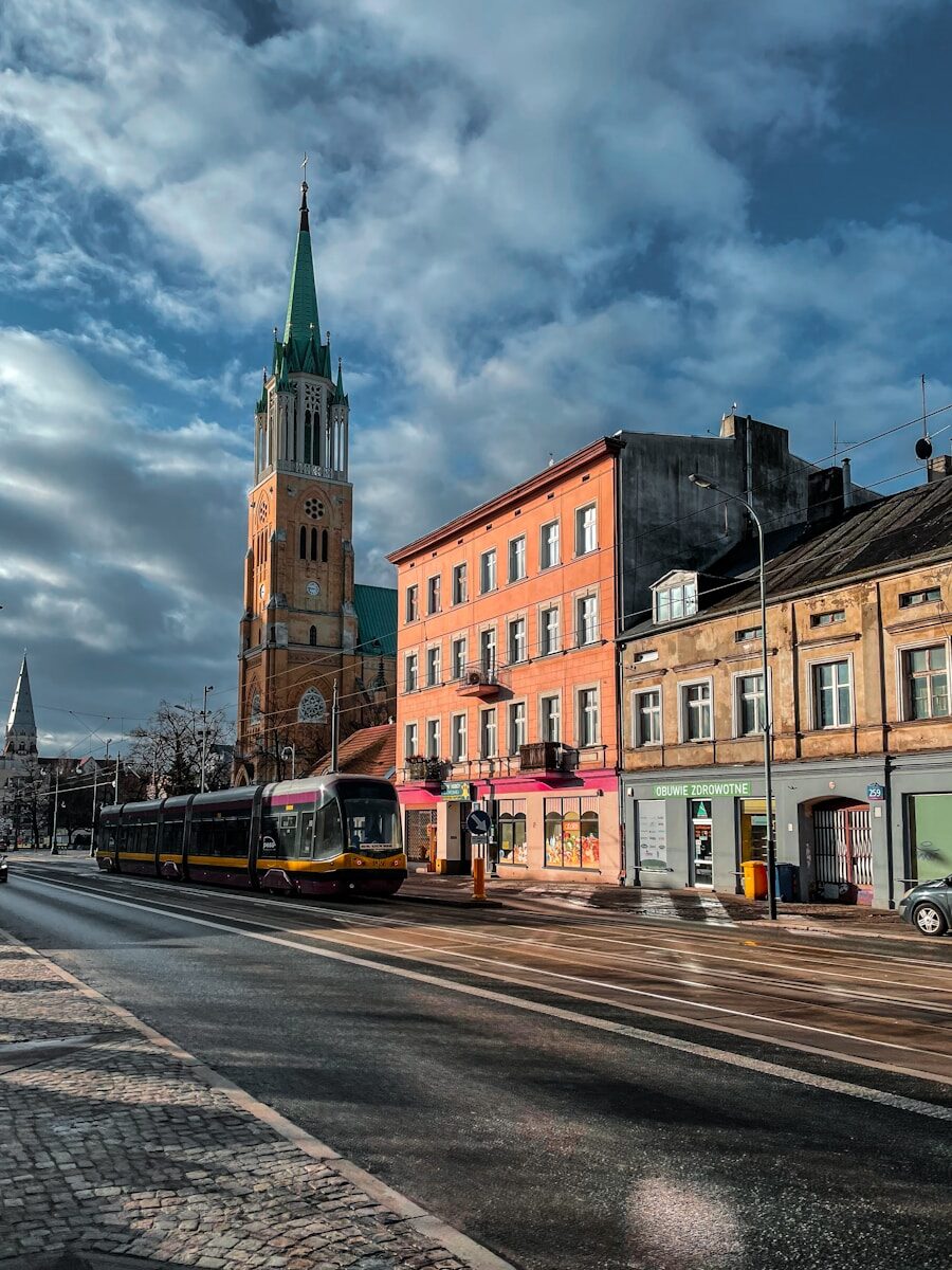 a city street with buildings and a train on the tracks